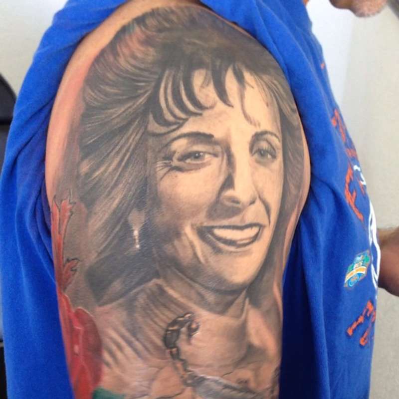 realistic portrait tattoo on upper arm