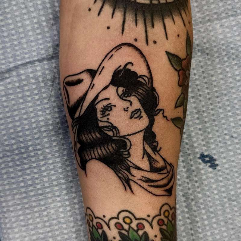 traditional pin-up girl tattoo on a forearm