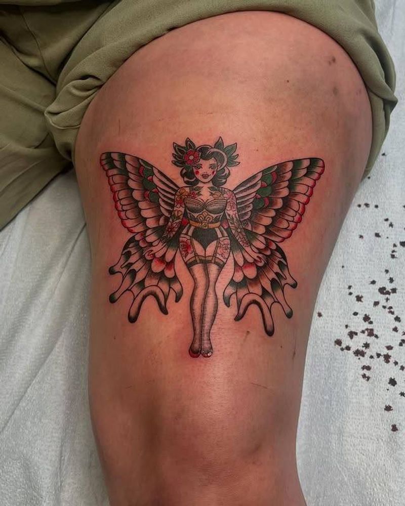 colorful tattoo of a woman with butterfly wings on thigh
