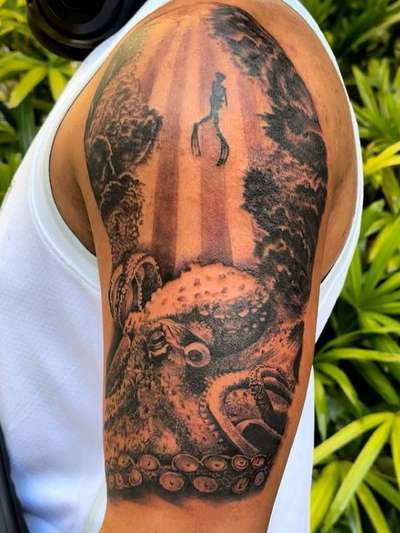 Black and grey realistic octopus on upper arm