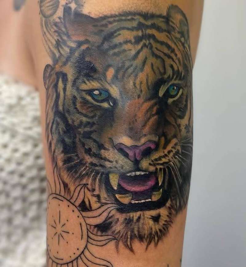 realistic tiger head tattoo in color on upper arm