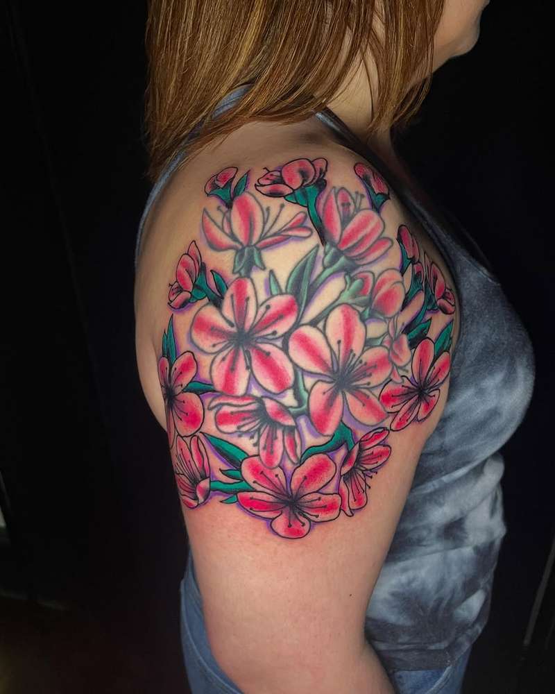 Colorful botanical cherry blossom tattoo on upper arm