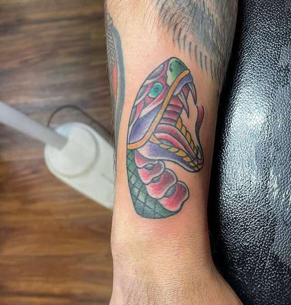Colorful Japanese snake tattoo on forearm