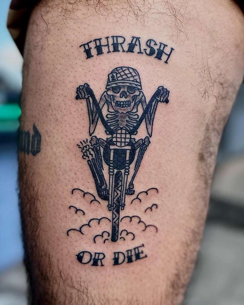 skeleton riding motorcycle tattoo on thigh