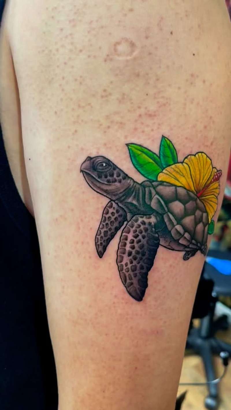 colorful sea turtle and flower tattoo on upper arm