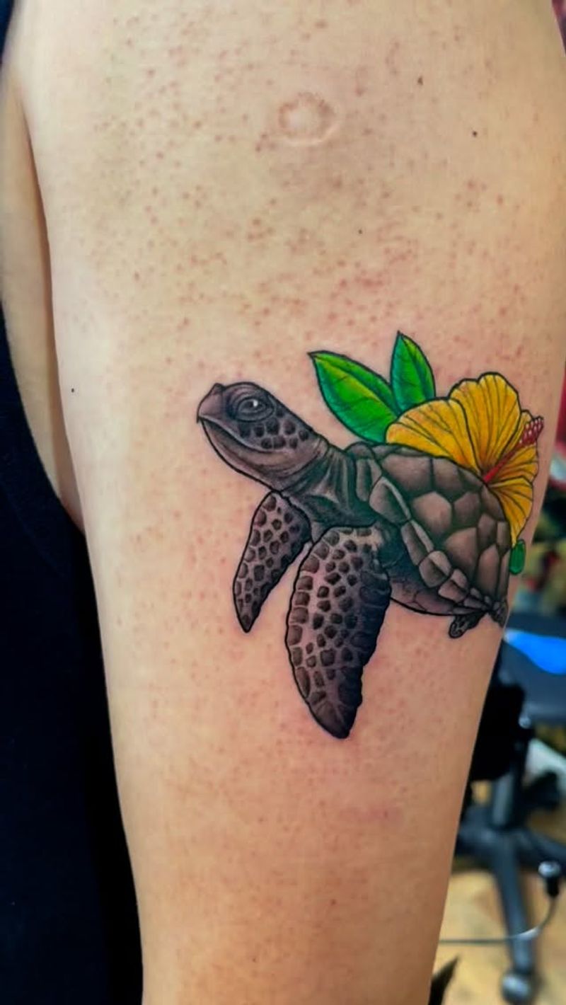 colorful sea turtle and flower tattoo on upper arm