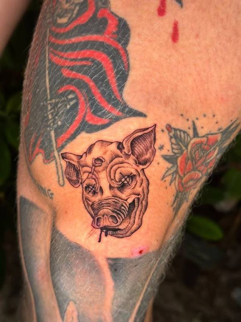 Blackwork pig head tattoo on upper arm