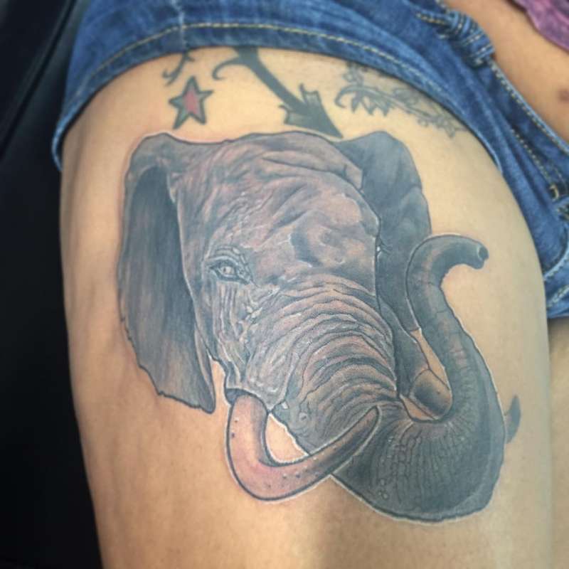realistic elephant head tattoo on thigh