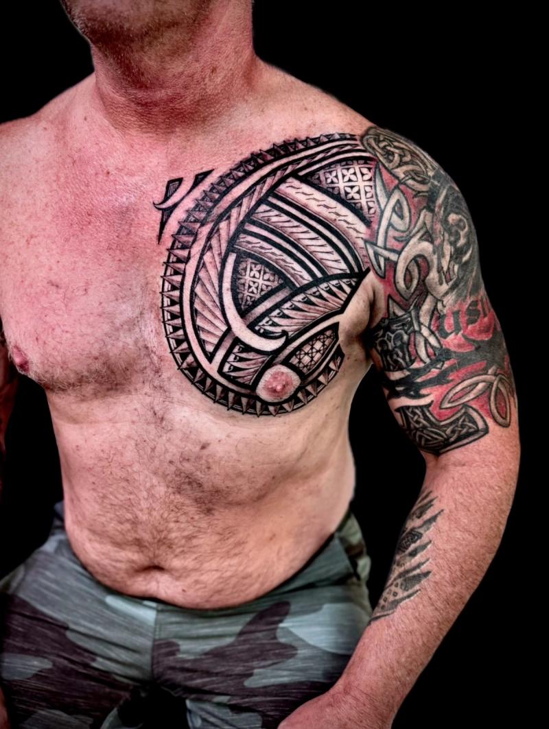 Tribal blackwork tattoo on shoulder and chest