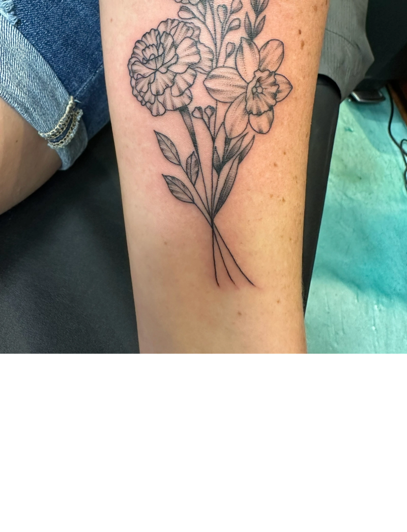 Black and grey fine line floral tattoo on thigh