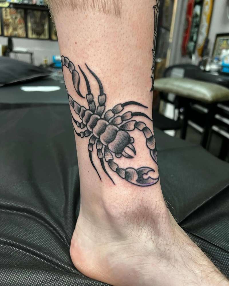 Black and grey traditional scorpion tattoo on calf