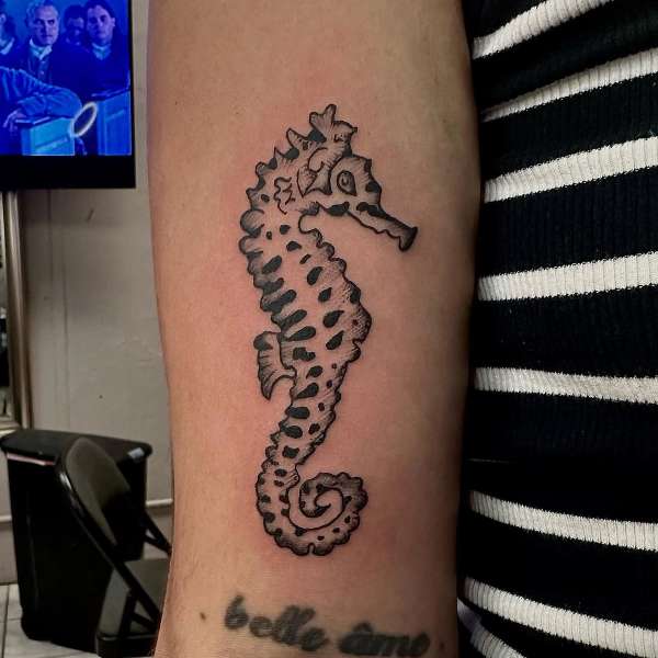 blackwork seahorse tattoo on forearm