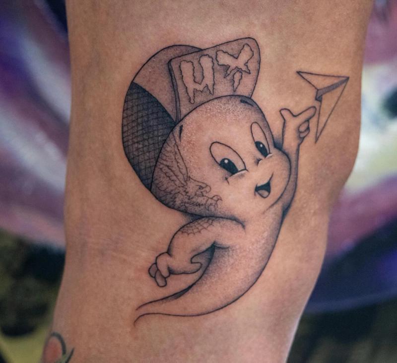 Black and grey cartoon ghost tattoo on forearm