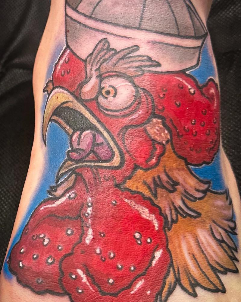 colorful rooster tattoo on calf