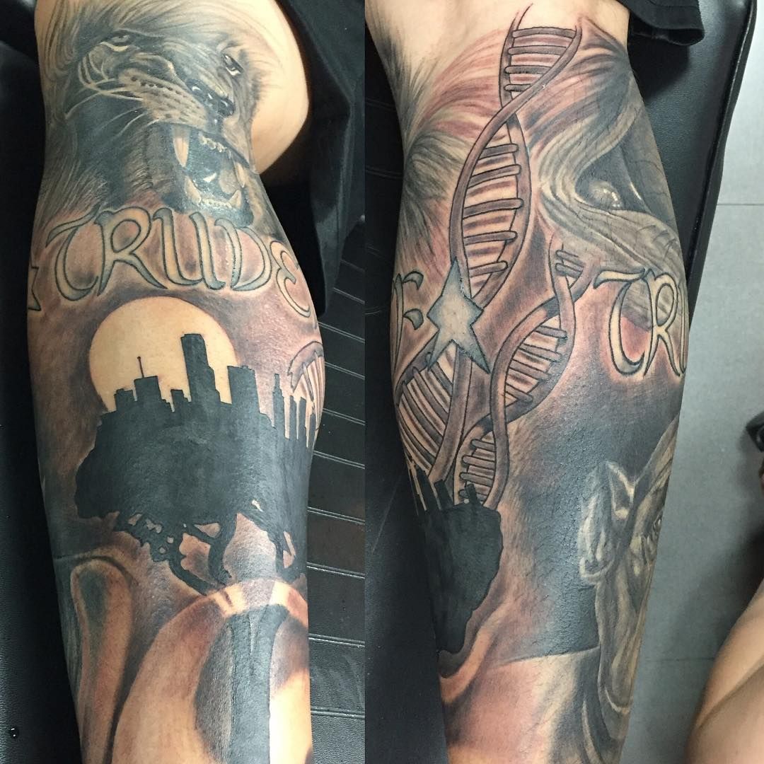 Black and grey lion with cityscape and DNA on full sleeve