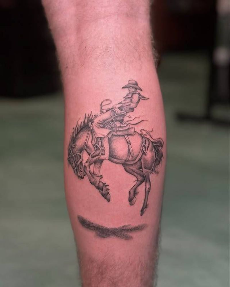 Black and grey realistic cowboy on horse tattoo on calf