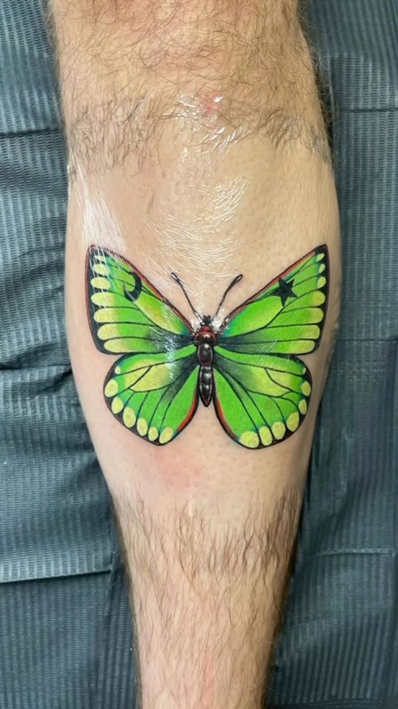 green and black butterfly tattoo on calf