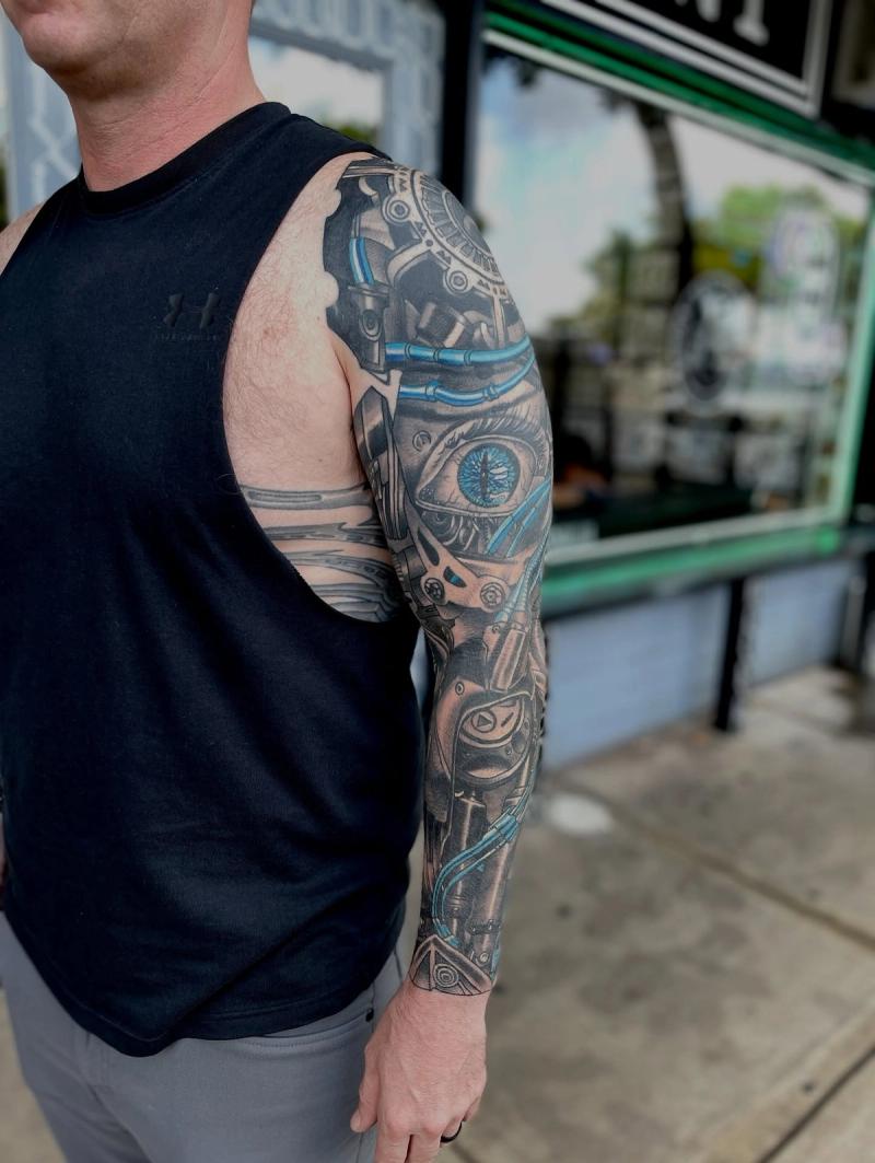 biomechanical full sleeve tattoo with robot eye and mechanical parts