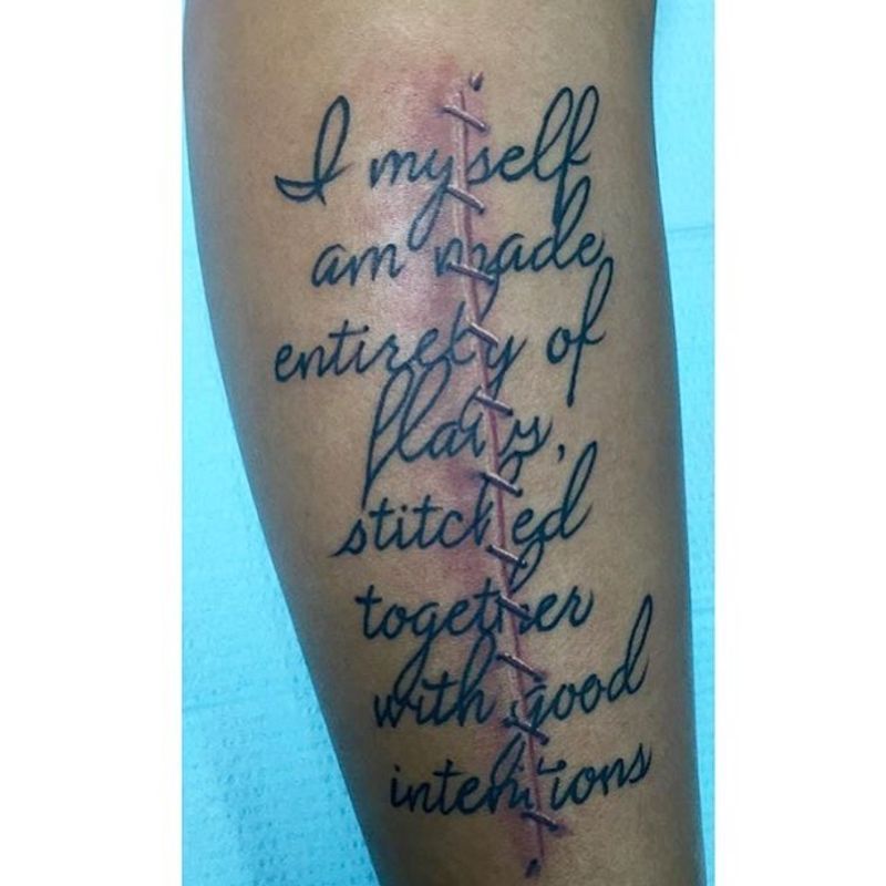 script lettering tattoo on calf