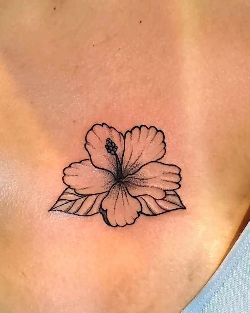 Blackwork hibiscus flower tattoo on upper back