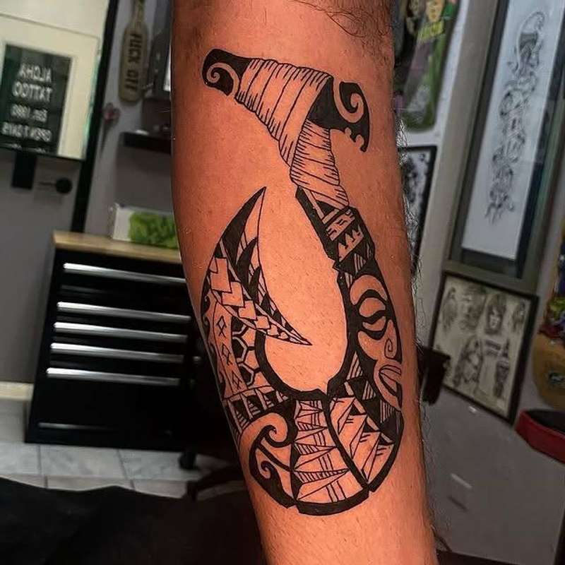tribal hook tattoo on forearm