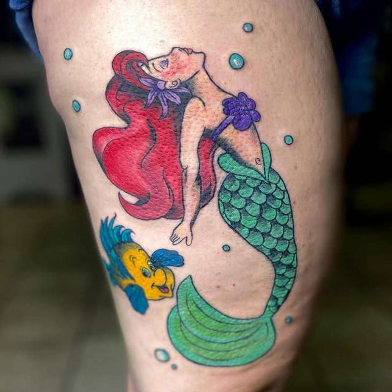 colorful mermaid and fish tattoo on thigh