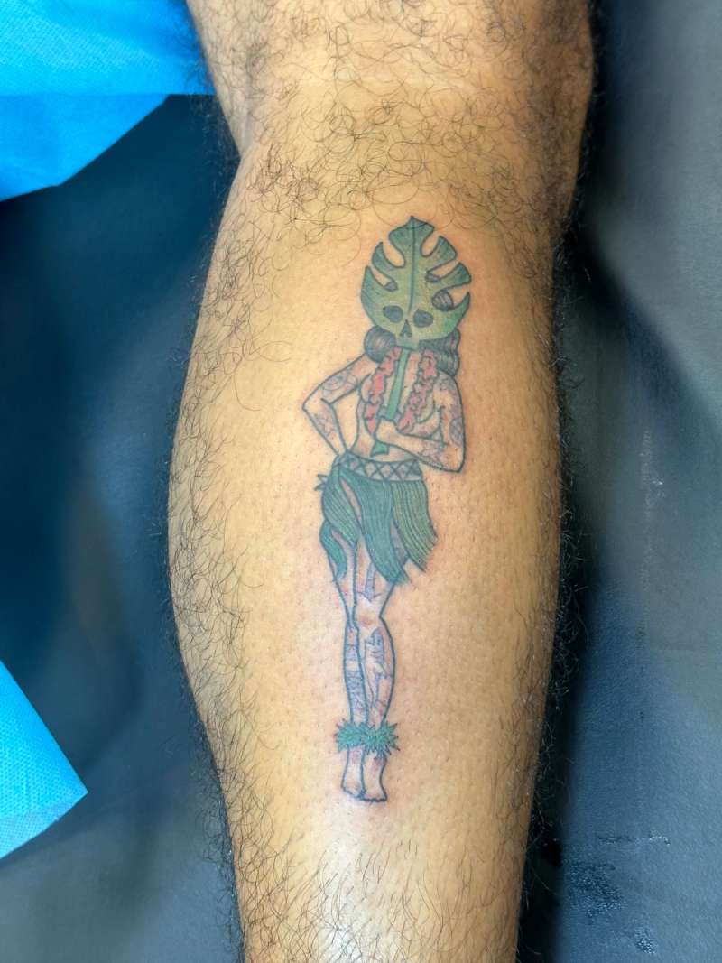 Colorful illustrative hula dancer tattoo on calf