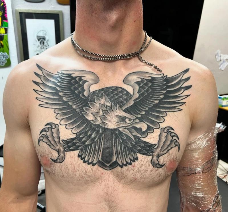 Black and grey traditional eagle tattoo on chest