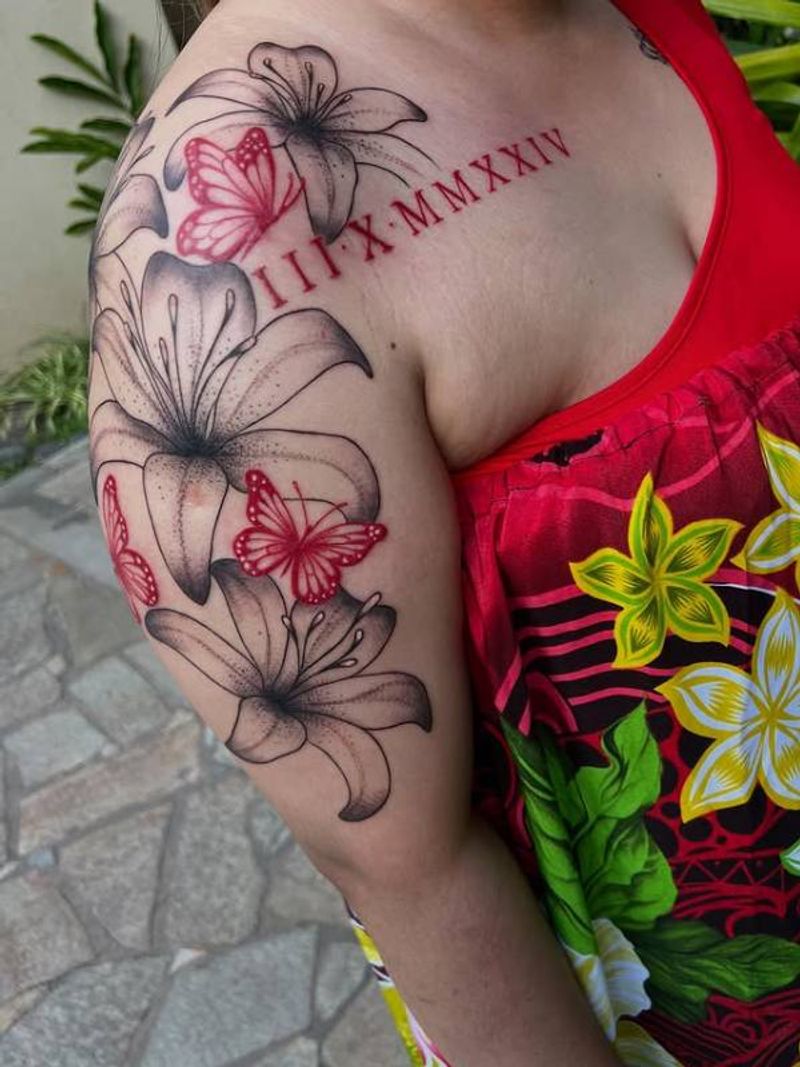 upper arm tattoo of flowers with roman numerals and butterflies