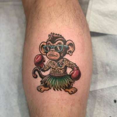 Colorful cartoon monkey with boxing gloves on a calf.