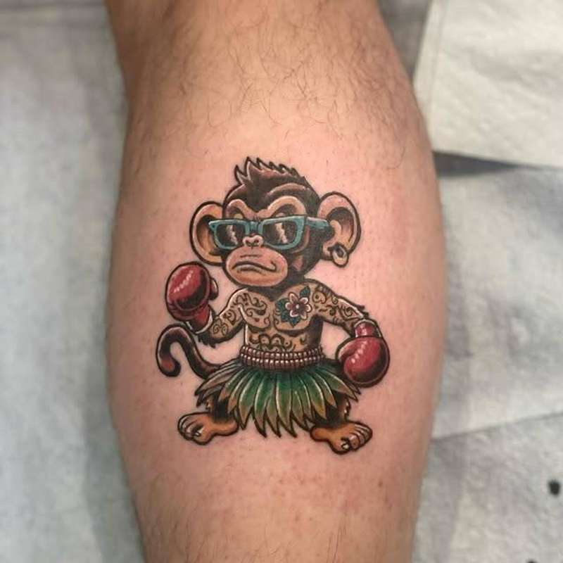 Colorful cartoon monkey with boxing gloves on a calf.