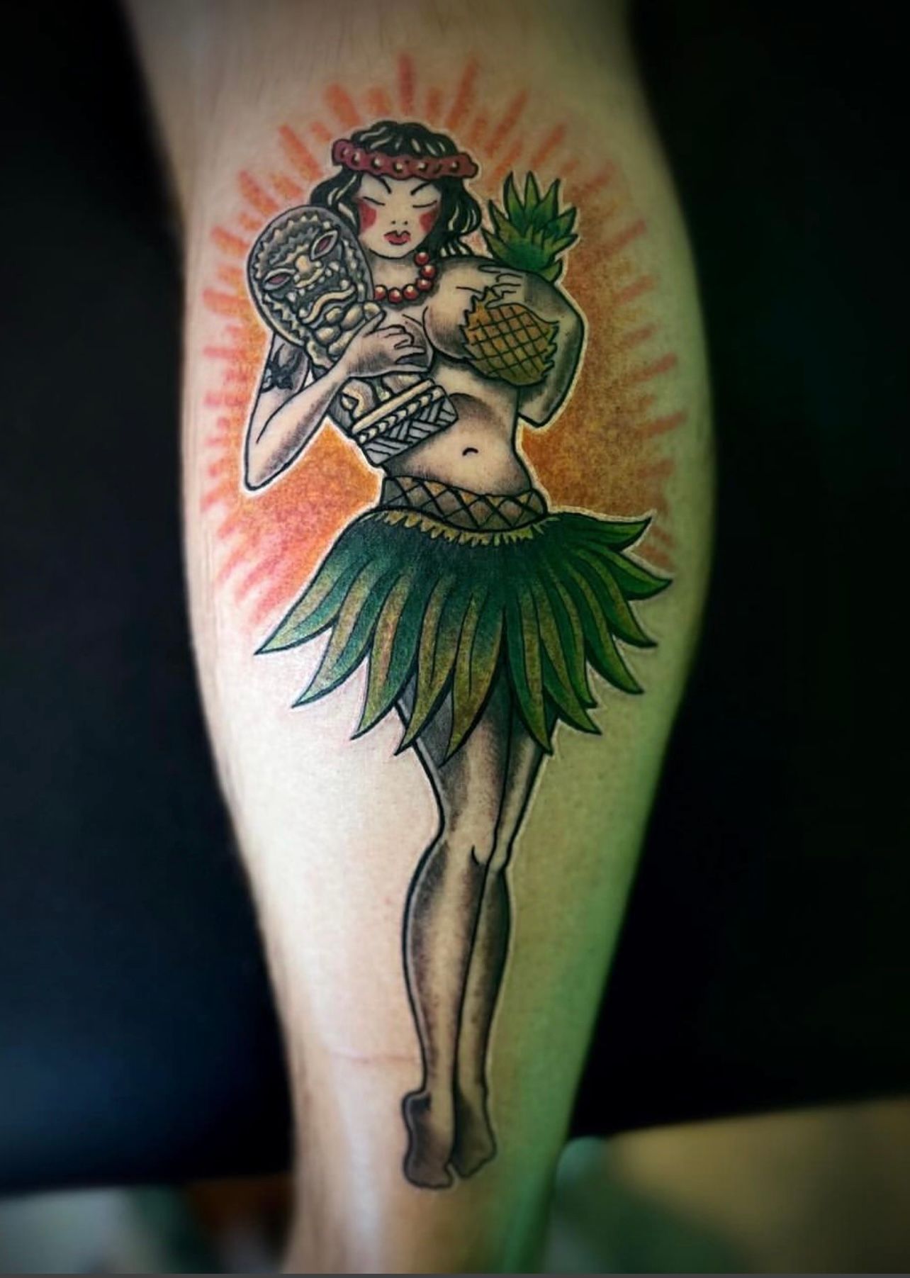 Traditional colorful hula girl tattoo on calf