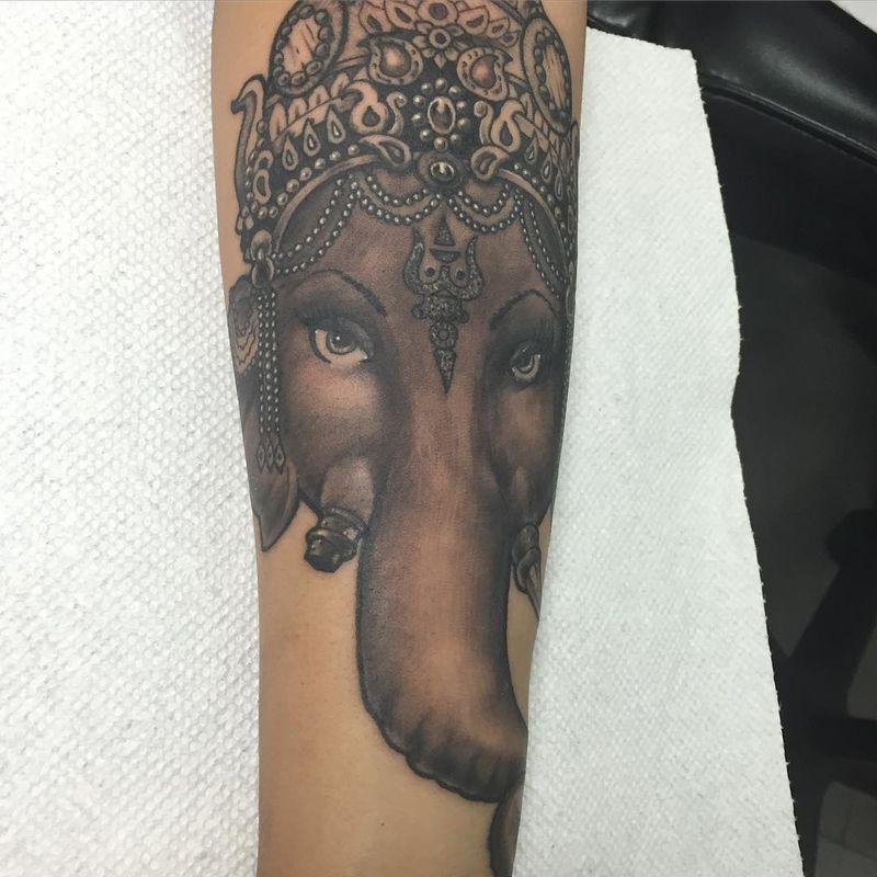 Black and grey realistic elephant tattoo on forearm
