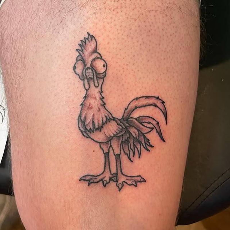 Black and grey cartoon rooster tattoo on thigh