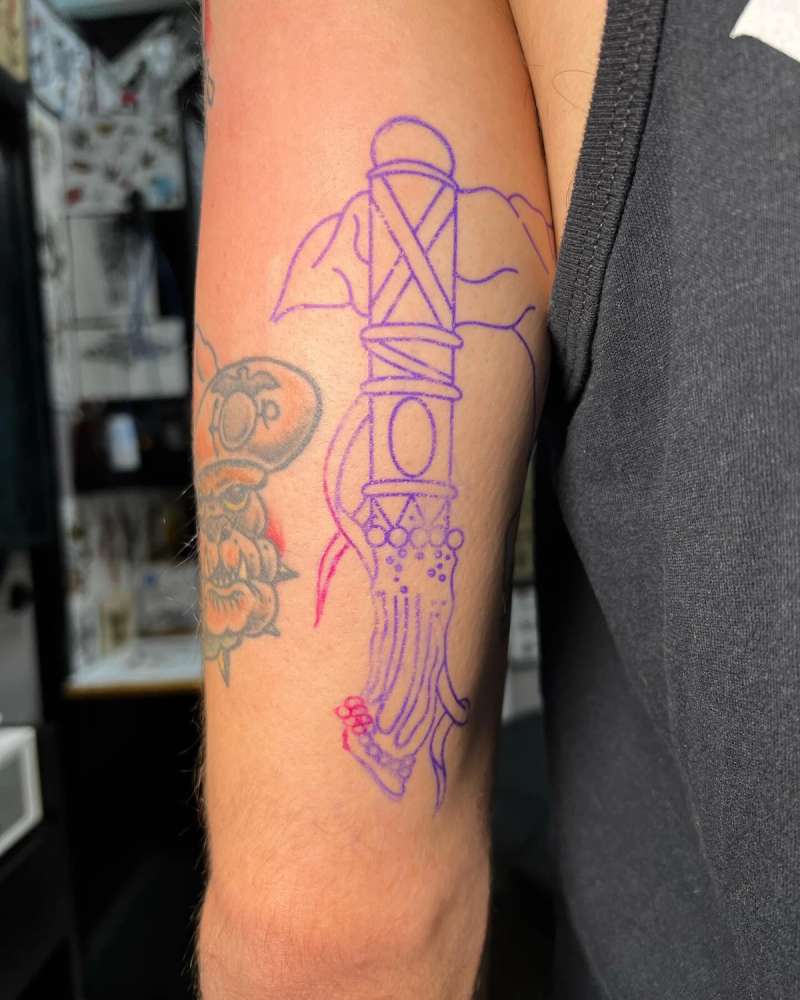 Outline of a traditional sword tattoo on upper arm.