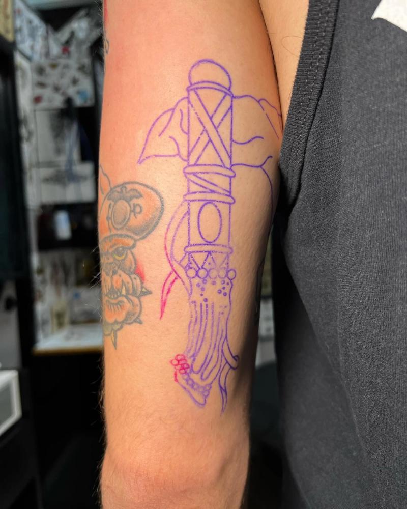 Outline of a traditional sword tattoo on upper arm.