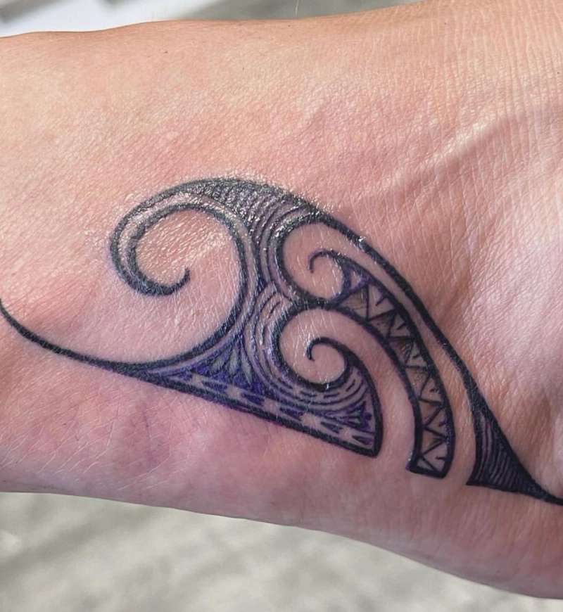 Blackwork tribal swirl tattoo on hand