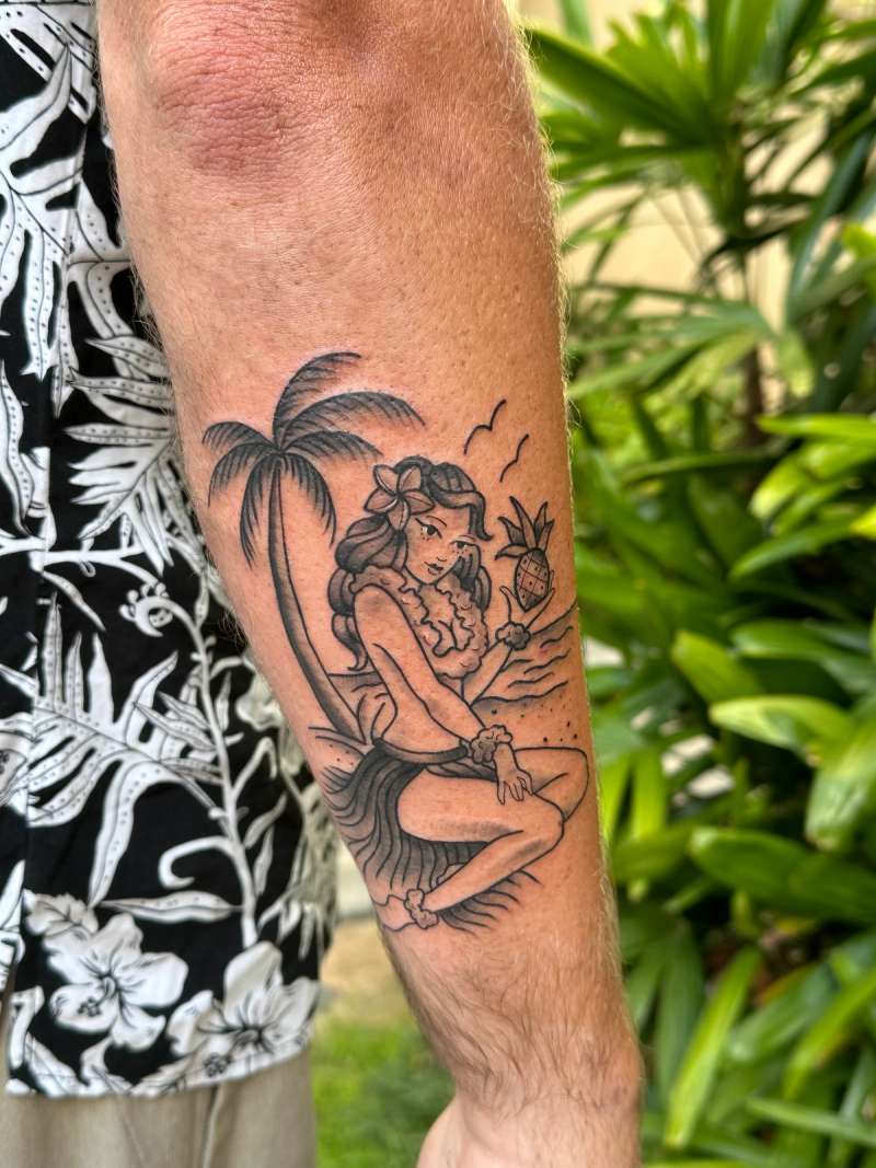 Black and grey illustrative tattoo of a hula girl on forearm