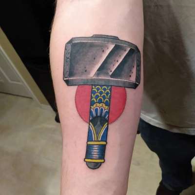 colorful hammer tattoo on forearm