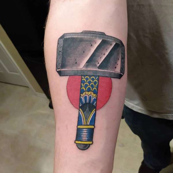 colorful hammer tattoo on forearm