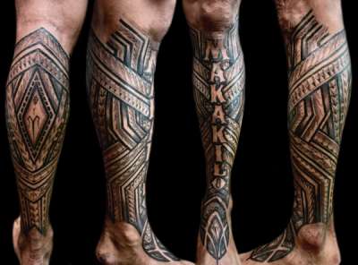 Black and grey tribal and lettering tattoo on calf