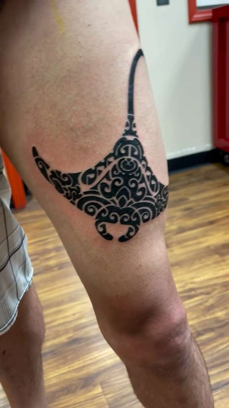 tribal style manta ray tattoo on thigh