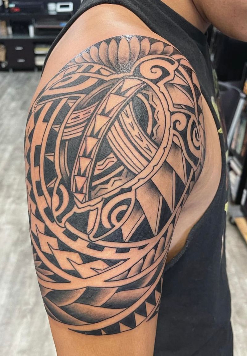 Black and grey tribal design on upper arm
