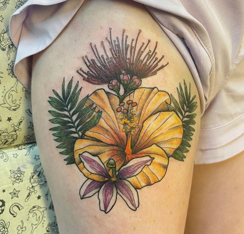 Colorful illustrative floral tattoo on thigh