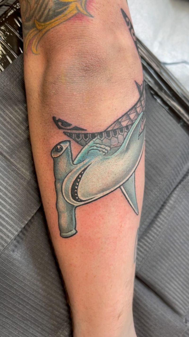 colorful shark tattoo on forearm