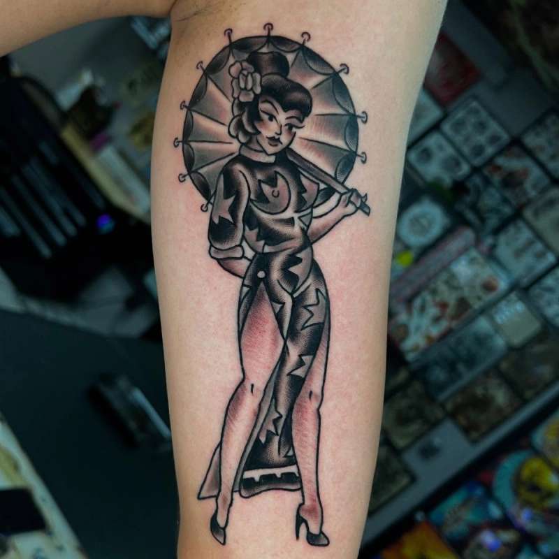 Black and grey traditional woman with umbrella tattoo on forearm