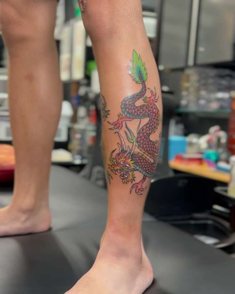 Colorful Japanese traditional dragon tattoo on calf