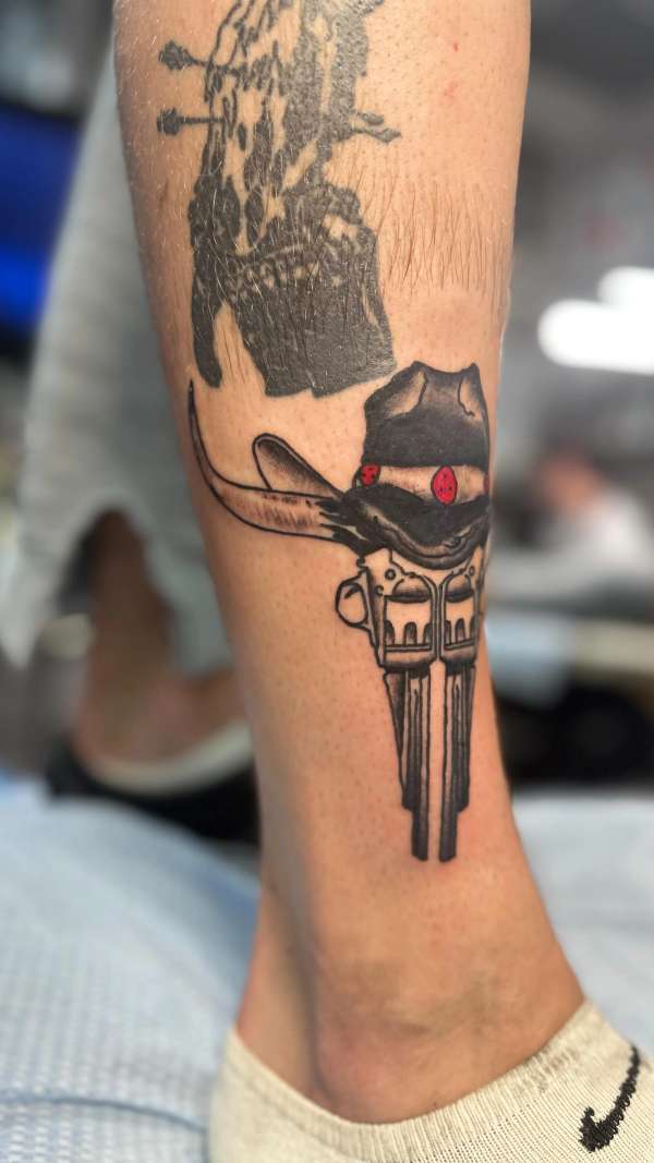 tattoo of a cowboy hat and skull on calf