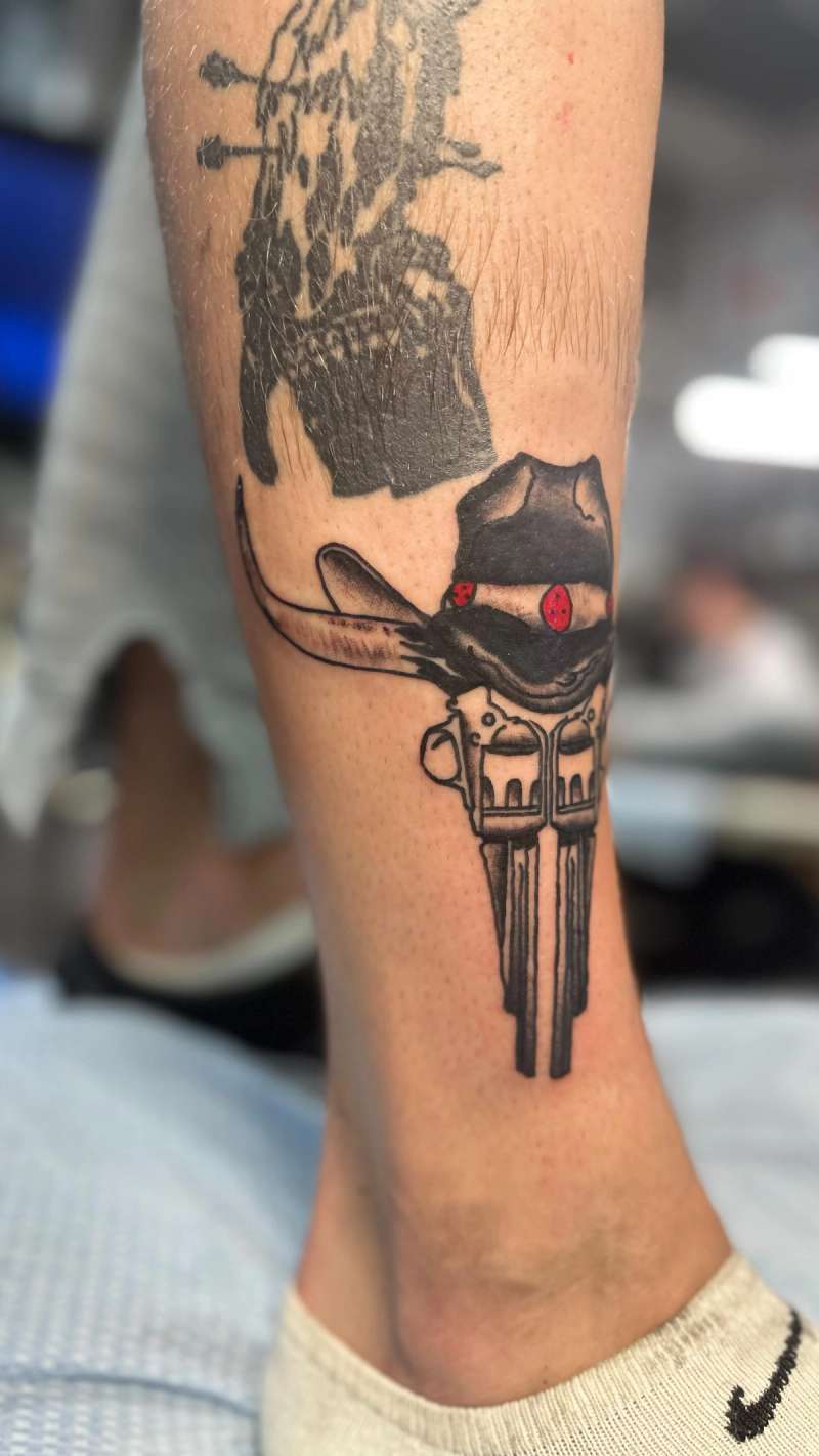 tattoo of a cowboy hat and skull on calf
