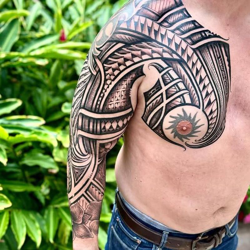 Blackwork tribal and geometric full sleeve tattoo on arm